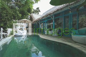 Area outdoor bernuansa bohemian tropis dengan private pool